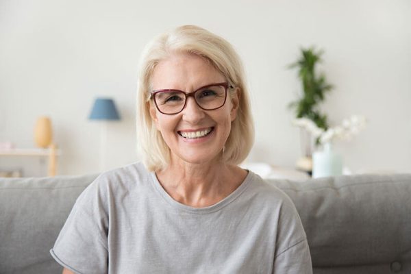 middle aged woman with glasses smiling