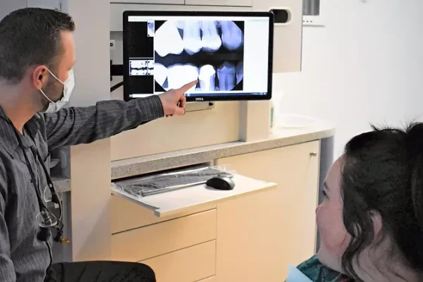 Dr. Dawson showing a patient their X-ray images.
