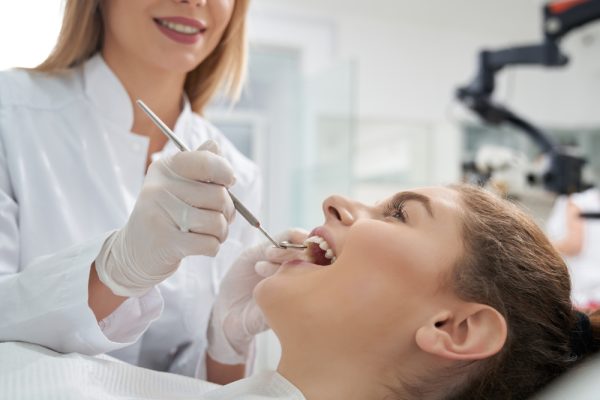 woman getting her teeth checked at the dentist