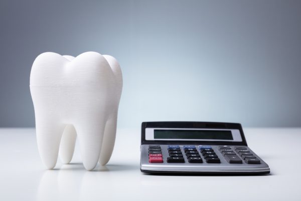 fake tooth next to a calculator