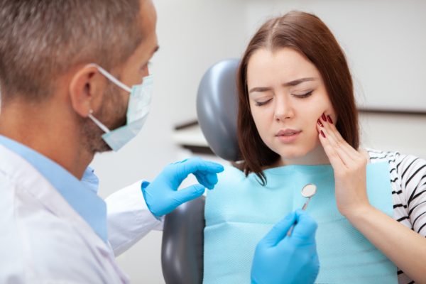 woman at the dentist with tooth pain