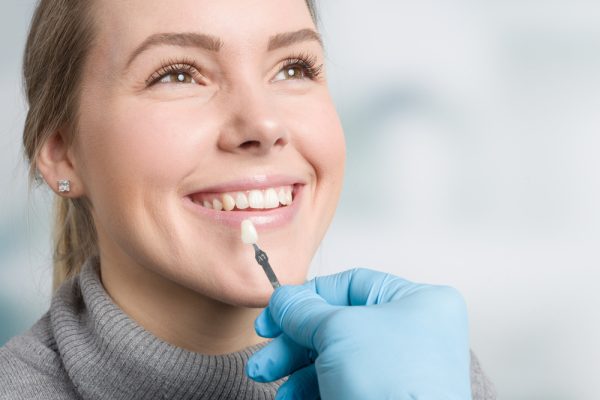 patient getting color matched for a dental crown