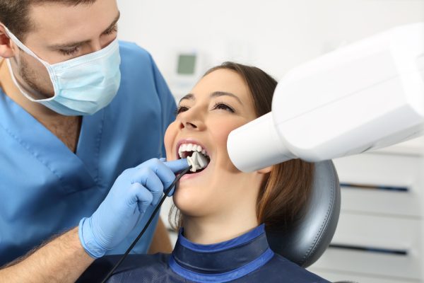 dentist taking dental x-rays for patient
