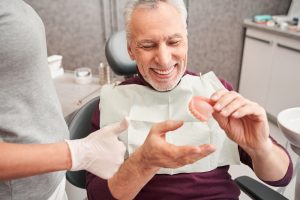 dentist giving a patient their dentures